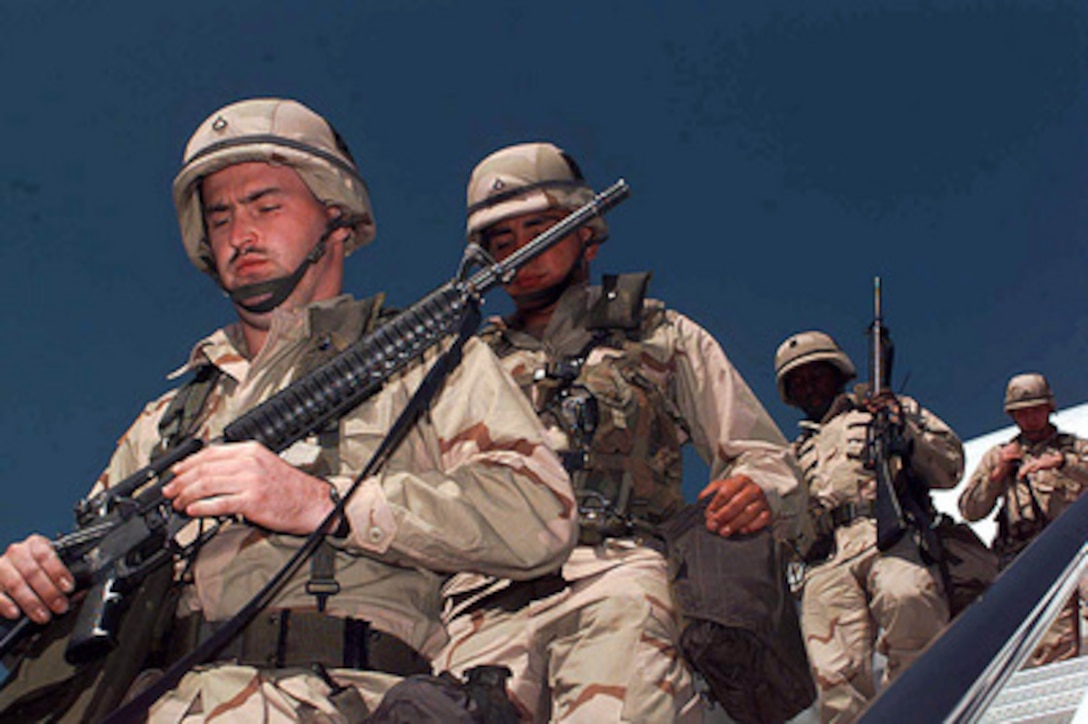 U.S. Army soldiers from Fort Stewart, Ga., arrive at an operating base in Southwest Asia on Feb. 19, 1998, during Operation Southern Watch. Southern Watch is the U.S. and coalition enforcement of the no-fly-zone over southern Iraq. 