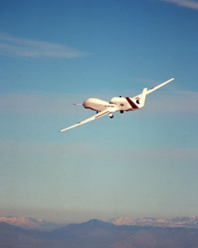 Global Hawk, the Department of Defense's newest reconnaissance aircraft, flies over Edwards Air Force Base, Calif., on Feb. 28, 1998, during its first flight. Global Hawk is a high-altitude, long-endurance, unmanned air vehicle designed to operate with a range of 13,500 nautical miles, at altitudes up to 65,000 feet and with an endurance of 40 hours. During a typical reconnaissance mission, the aircraft can fly 3,000 miles to an area of interest, remain on station for 24 hours, survey an area the size of the state of Illinois (40,000 square nautical miles), and then return 3,000 miles to its operating base. Sensors onboard the aircraft can provide near-real-time imagery of the area of interest to the battlefield commander via world-wide satellite communication links and the system's ground segment. 