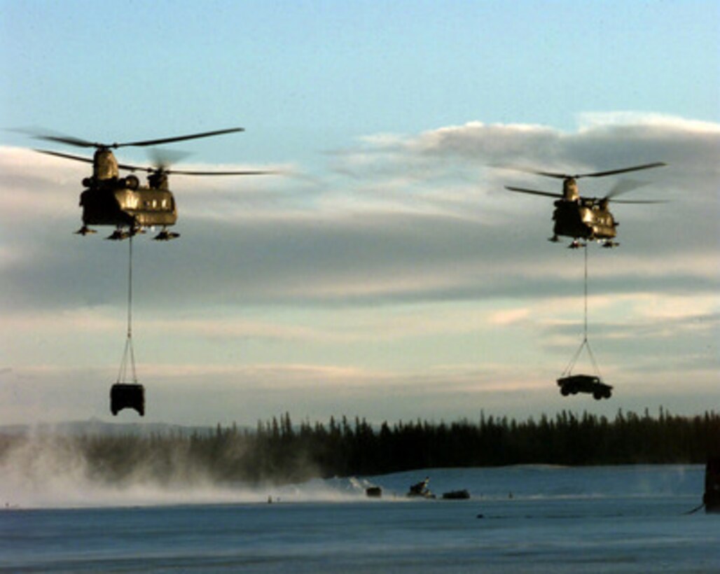 Two U.S. Army CH-47 Chinook helicopters sling load Humvees at Allen Army Airfield, Fort Greeley, Alaska, on Feb. 23, 1998, during Exercise Northern Edge 98. More than 90,000 soldiers, sailors, Marines, airmen Coast Guardsmen and National Guardsmen are participating the exercise. Northern Edge 98 is designed to practice joint operational techniques and procedures, increasing interoperability between the services. 