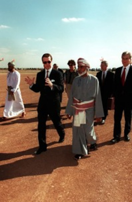 Secretary of Defense William S. Cohen (left) is welcomed to the desert encampment of Sultan Qaboos bin Said Al Said (right) of the Sultanate of Oman on Feb. 10, 1998. From left to right: His Excellency Sayyid Badr bin Sa'ud Al-Busaidi, Minister Responsible for Defense; Cohen; U.S. Ambassador to Oman Frances Cook; Sultan Qaboos; Under Secretary of Defense for Policy Walter Slocombe; and Sen. John W. Warner (R-Va.). 