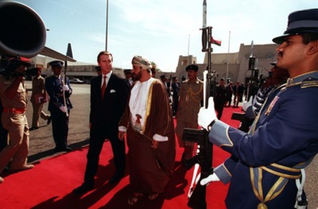 His Excellency Sayyid Badr bin Sa'ud Al-Busaidi (right), minister responsible for defense, escorts Secretary of Defense William S. Cohen (left) through an armed forces honor cordon as he leaves the Sultanate of Oman on Feb. 10, 1998. 