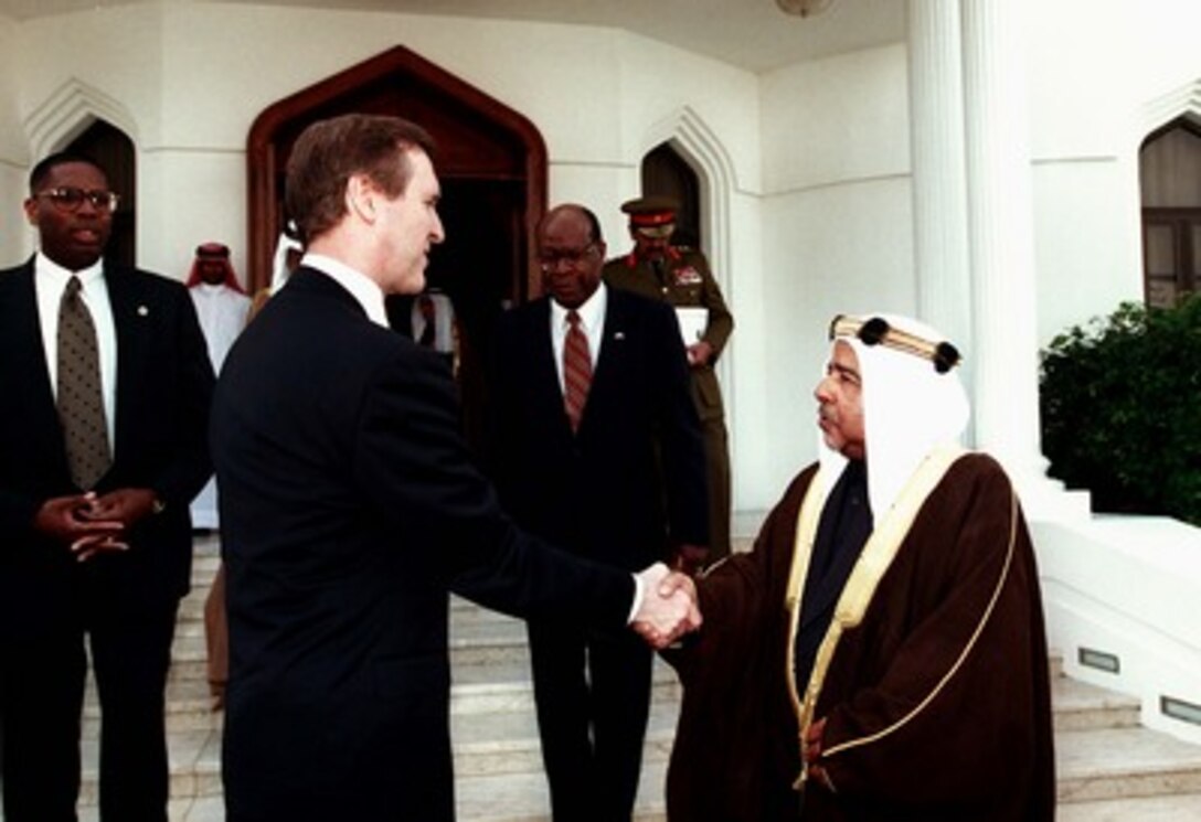 His Highness the Amir Shaikh bin Sulman Al Khalifa (right) bids farewell to Secretary of Defense William S. Cohen (left) at Rifa'a Palace, Bahrain, on Feb. 11, 1998. Accompanying Secretary Cohen is U.S. Ambassador to Bahrain Johnny Young (center). 