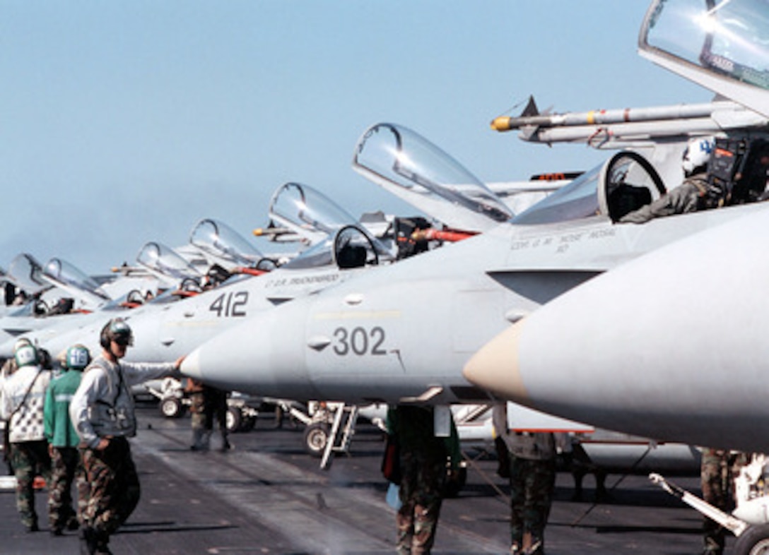 Flight deck crews prepare a swarm of F/A-18C Hornets for the morning's flight operations aboard the aircraft carrier USS George Washington (CVN 73 as the ship steams in the Persian Gulf on Feb. 20, 1998. The Washington battle group is operating in the Persian Gulf in support of Operation Southern Watch which is the U.S. and coalition enforcement of the no-fly-zone over Southern Iraq. 