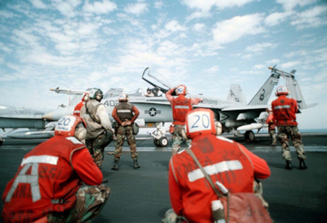 Flight deck crewmen assigned to Strike Fighter Squadron 86 prepare an F/A-18C Hornet for launch on the flight deck of the aircraft carrier USS George Washington (CVN 73) as the ship steams in the Persian Gulf on Feb. 21, 1998. The Washington and its embarked Carrier Air Wing 1 is operating in the Persian Gulf in support of Operation Southern Watch which is the U.S. and coalition enforcement of the no-fly-zone over Southern Iraq. The Hornet is from Strike Fighter Squadron 86, Naval Air Station Cecil Field, Fla. 