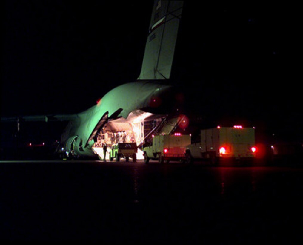 Vehicles and equipment from the U.S. Army 11th Air Defense Artillery Brigade are loaded on board a U.S. Air Force C-5 Galaxy at El Paso International Airport, Texas, on Feb. 23, 1998. The 11th is deploying to the Persian Gulf area of operations as part of a force augmentation in Southwest Asia. 