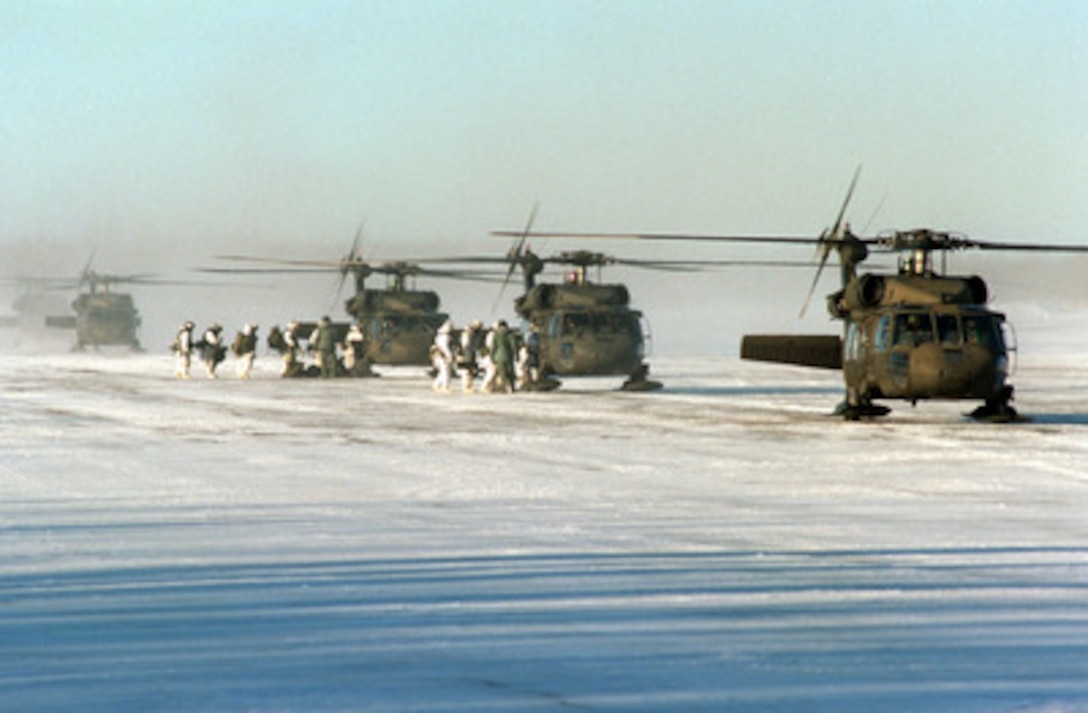 U.S. Army UH-60L Black Hawk helicopters load soldiers at Allen Army Air Field, Fort Greely, Alaska, on Feb. 19, 1998, for an air assault on the fictional town of Simpsonville in the Yukon Training Area during Exercise Northern Edge 98. More than 90,000 soldiers, sailors, Marines, airmen, Coast Guardsmen and National Guardsmen are participating the exercise. Northern Edge 98 is designed to practice joint operational techniques and procedures, increasing interoperability between the services. The helicopters are D Company, 4th Battalion, 123rd Aviation Regiment, Fort Wainwright, Alaska. The soldiers are from the 1st Battalion, 17th Regiment, 1st Brigade, 6th Infantry Division, Fort Greely, Alaska. 