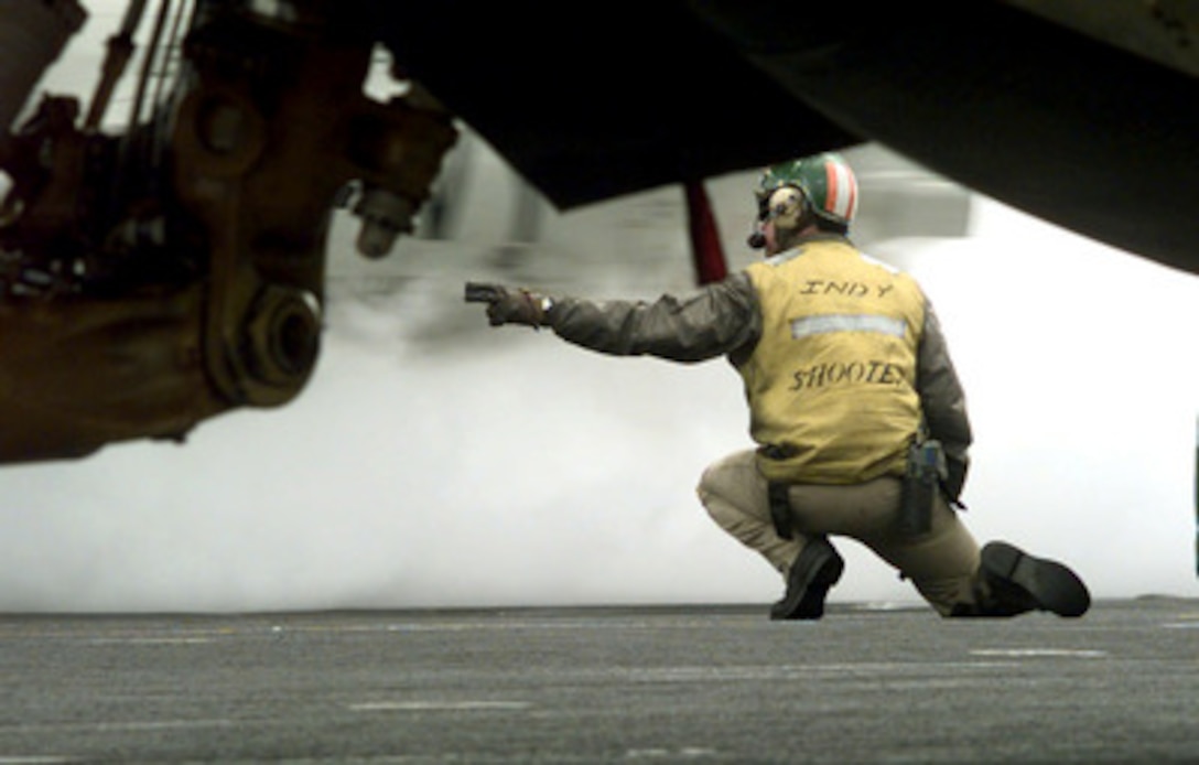 Lt. John Tucke, U.S. Navy, launches a fighter jet from the flight deck of the USS Independence (CV 62) while the ship operates in the Persian Gulf on Feb. 28, 1998. Independence and its embarked Carrier Air Wing 5 are on station in the Persian Gulf in support of Operation Southern Watch which is the U.S. and coalition enforcement of the no-fly-zone over Southern Iraq. 