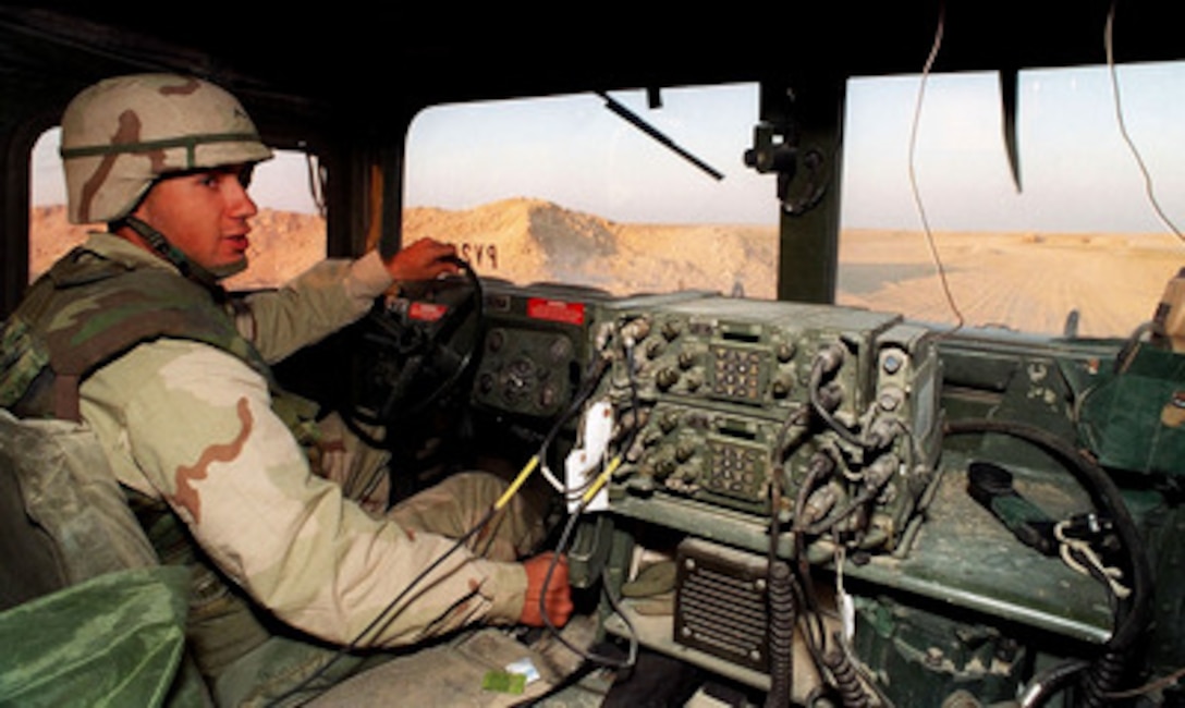 Pvt. Wesley Chism, U.S. Army, uses a Humvee to conduct a morning patrol around the perimeter of a Army base camp in the Kuwaiti desert on March 2, 1998. Chism is attached to Alpha Company of the 11th Engineers, Fort Stewart, Ga., which are deployed to Kuwait as part of a force augmentation in Southwest Asia. 