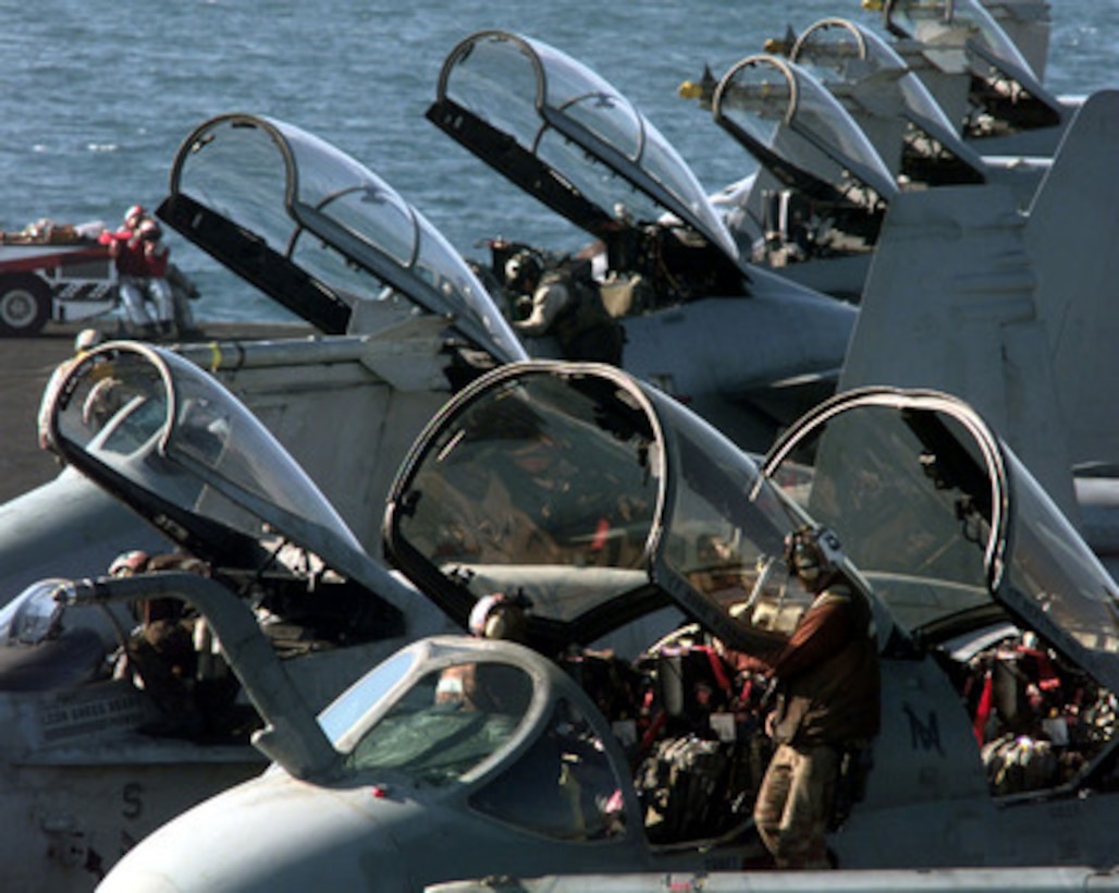 U.S. Navy EA-6B Prowlers, F/A Hornets and F-14 Tomcats are given preflight checks by their plane captains on the flight deck of the USS Independence (CV 62) while the ship operates in the Persian Gulf on March 3, 1998. Independence and its embarked Carrier Air Wing 5 are on station in the Persian Gulf in support of Operation Southern Watch which is the U.S. and coalition enforcement of the no-fly-zone over Southern Iraq. 