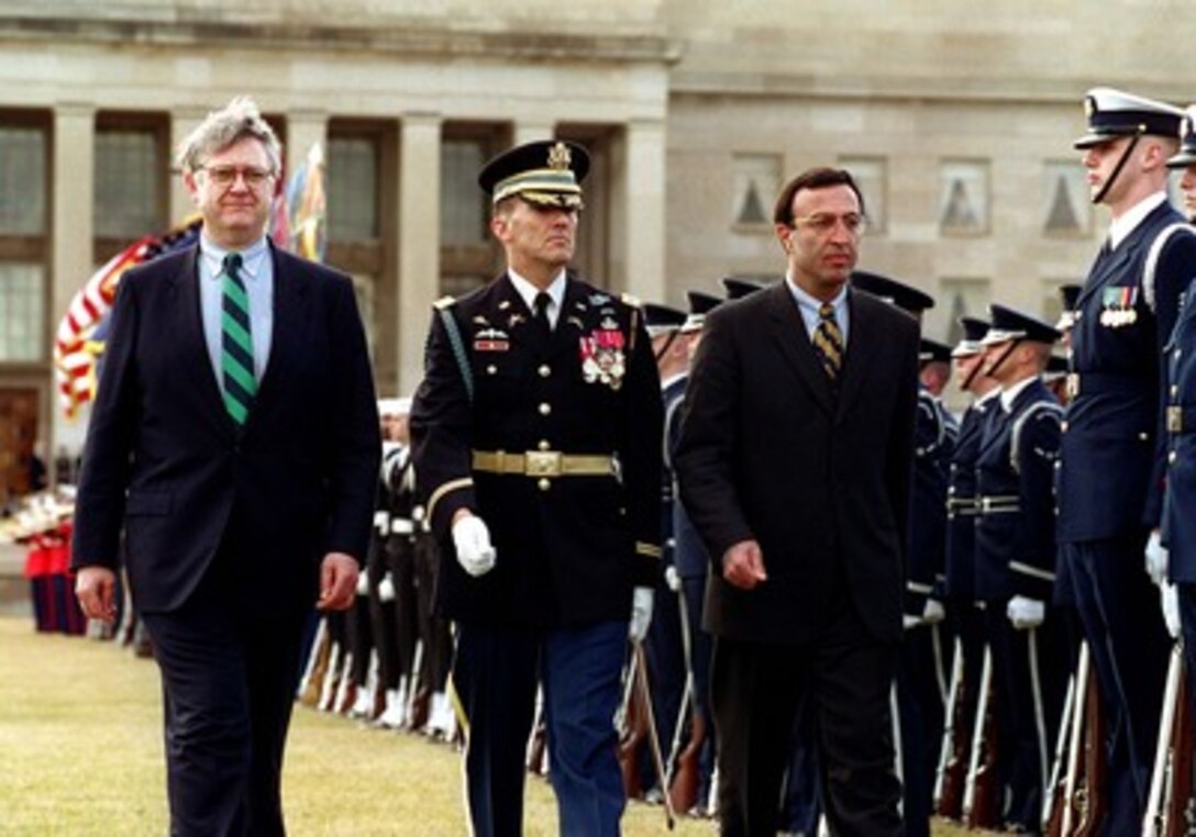 Deputy Secretary of Defense John Hamre (left) and President Peter Stoyanov of Bulgaria (right) are escorted by Commander of Troops, Col. Gregory Gardner, U.S. Army (center), as they inspect the joint services honor guard during a Pentagon ceremony on Feb. 12, 1998. Stoyanov will later meet with Hamre and other DoD officials to discuss a range of security issues of interest to both nations. 