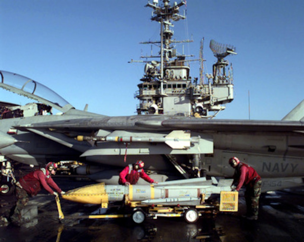 Sailors from the ordnance department of the USS Independence (CV 62) prepare to load an AIM-54C Phoenix missile onto the wing of an F-14 Tomcat on the flight deck of the USS Independence (CV 62) while the ship operates in the Persian Gulf on March 4, 1998. Independence and its embarked Carrier Air Wing 5 are on station in the Persian Gulf in support of Operation Southern Watch which is the U.S. and coalition enforcement of the no-fly-zone over Southern Iraq. The Tomcat is attached to Fighter Squadron 154, Naval Air Facility Atsugi, Japan. 