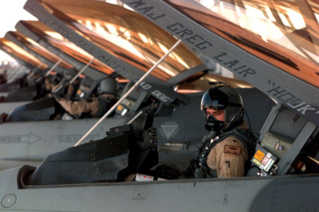 U.S. Air Force Capt. Phil Tau goes through his pre-flight checklist in a F-16 Fighting Falcon prior to launching for a combat patrol mission over Southern Iraq on March 5, 1998. Tau and other pilots of the 175th Fighter Squadron are deployed to Kuwait in support of Operation Southern Watch which is the U.S. and coalition enforcement of the no-fly-zone over Southern Iraq. The 175th is deployed from the 114th Fighter Wing, Sioux Falls, South Dakota Air National Guard. 