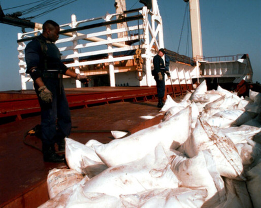 U.S. Navy Petty Officers Second Class Marvin Haynes (left) and Sean M. Finotti (right) count sacks on the deck of an Iranian cargo ship during a maritime interdiction operation in the Persian Gulf on March 6, 1998. Crew members from the USS John S. McCain (DDG-56) boarded and are inspecting the ship for possible contraband. The Arleigh Burke class destroyer is conducting the interception operations as part of a force augmentation in the region. The McCain is home ported in Yokosuka, Japan. 