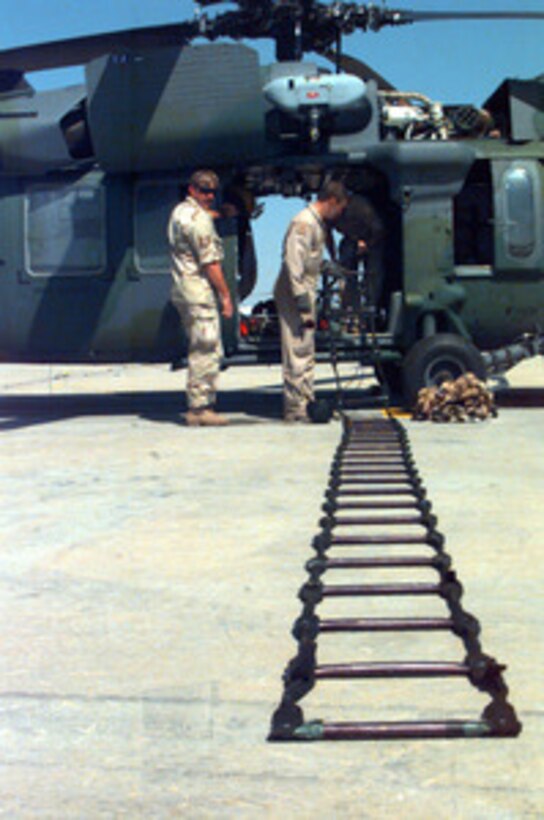 Maintenance and aircrew members check and catalog equipment for a U.S. Air Force MH/HH-60G Pave Hawk helicopter deployed to U.S. Army Camp Doha, Kuwait, on March 11, 1998. Pave Hawks and their crews are deployed from the 48th Rescue Squadron, 49th Fighter Wing, Holloman Air Force Base, N.M., and the 66th Rescue Squadron, 57th Wing, Nellis Air Force Base, Nev., to Kuwait as part of a force augmentation in Southwest Asia. 