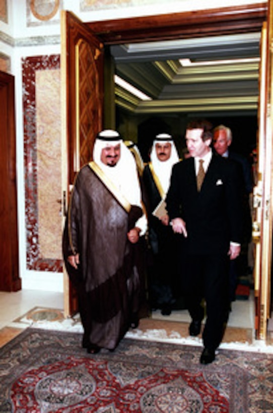 Minister of Defense and Aviation Prince Sultan bin Abd al Aziz Al Saud (left) escorts Secretary of Defense William S. Cohen (right), to see King Fahd bin Abd al-Aziz Al Saud at his palace on Feb. 8, 1998. Accompanying Cohen is U.S. Ambassador to the Kingdom of Saudi Arabia Wyche Fowler (in background). 