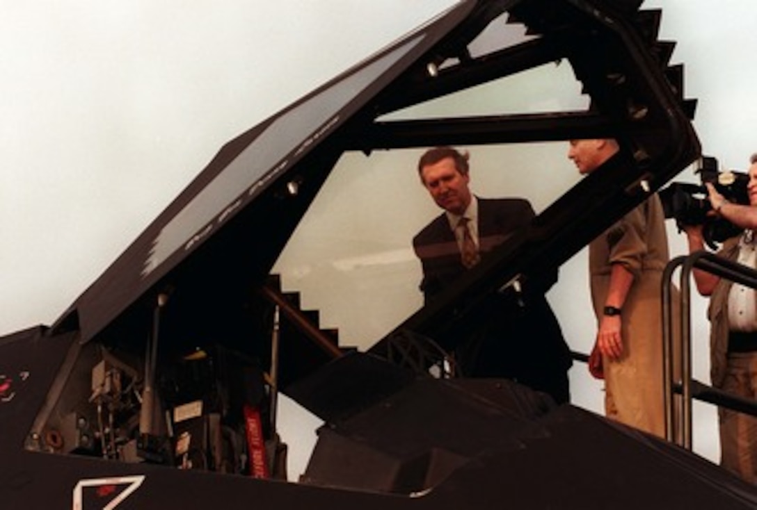 Secretary of Defense William S. Cohen looks into the cockpit of a U.S. Air Force F-117A Nighthawk while visiting with U.S. personnel at Al-Jaber Air Base, Kuwait, on Feb. 9, 1998. 