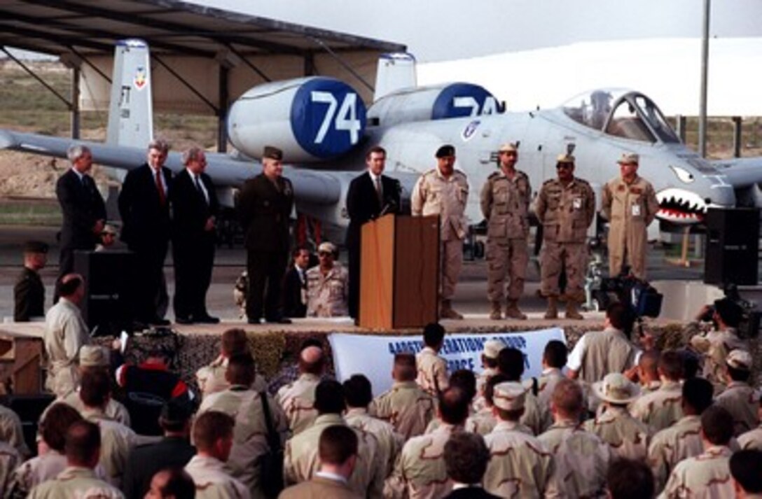 A U.S. Air Force A-10 Thunderbolt serves as a dramatic backdrop as Secretary of Defense William S. Cohen addresses U.S. personnel at Al-Jaber Air Base, Kuwait, on Feb. 9, 1998. The aircraft is deployed to Kuwait from the 23rd Fighter Group, Pope Air Force Base, N.C. 