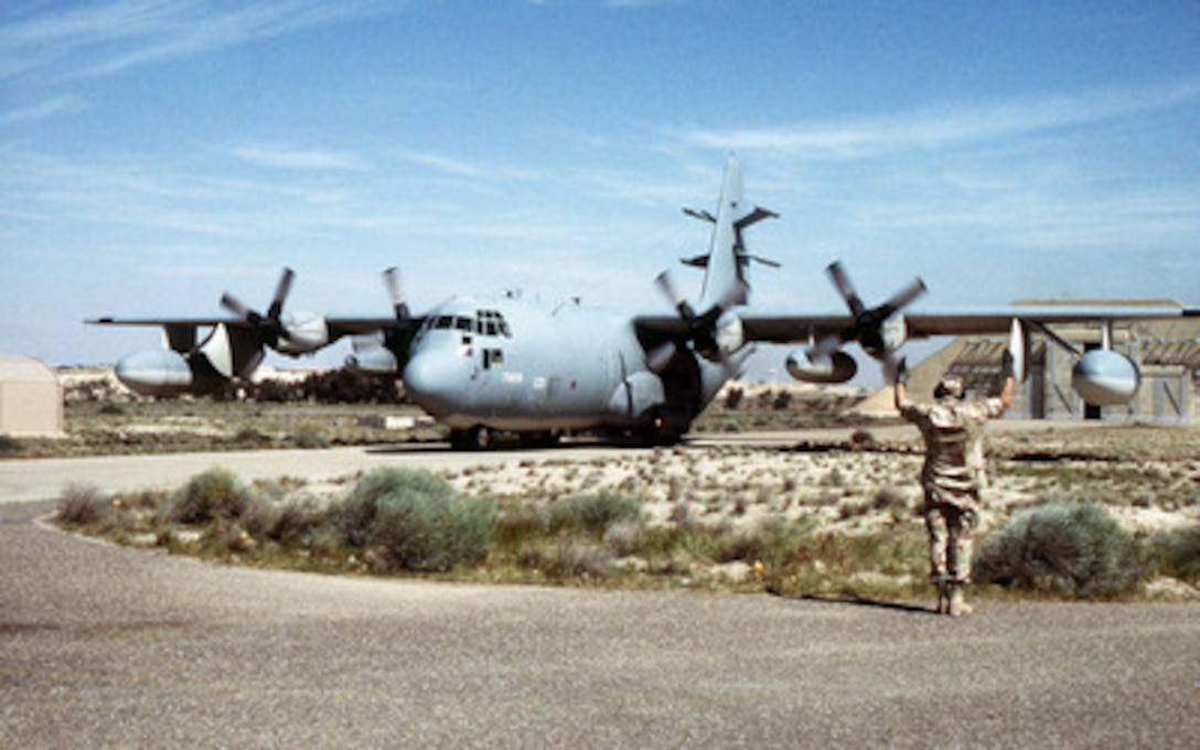 Senior Master Sgt. Tom Deffley directs the crew of a U.S. Air Force EC-130E Commando Solo as they taxi out for takeoff on a mission over Iraq on March 17, 1998. The Commando Solo is deployed to the Southwest Asia area of operations in support of Operation Southern Watch, which is the U.S. and coalition enforcement of the no-fly-zone over Southern Iraq. 