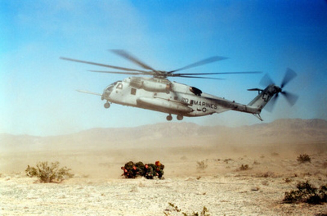 A U.S. Marine Corps reconnaissance team braces against the blast of rotor wash from a CH-53E Sea Stallion as the helicopter lifts off from the desert floor of the Marine Corps Air Ground Combat Center, Twentynine Palms, Calif., on Jan. 19, 1998. The Sea Stallion inserted the recon team from 1st Battalion, 8th Marines, as part of the Combined Arms Exercise 3-98. 