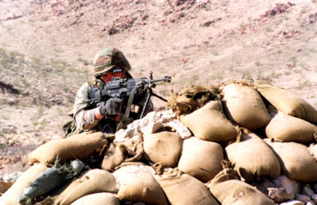 A Marine uses a M-249 Squad Automatic Weapon to provide cover fire for his fire team on Range 400 at the Marine Corps Air Ground Combat Center, Twentynine Palms, Calif., on Jan. 29, 1998. Marines from 1st Battalion, 8th Marine Regiment are taking part in Combined Arms Exercise 3-98. 