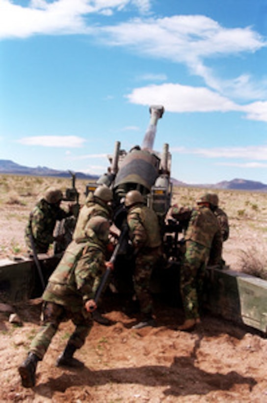 U.S. Marines from the 10th Marine Regiment prepare their M-198 155 mm howitzer for firing at the Marine Corps Air Ground Combat Center, Twentynine Palms, Calif., on Feb. 23, 1998. The Marines are taking part in Combined Arms Exercise 4-98. 