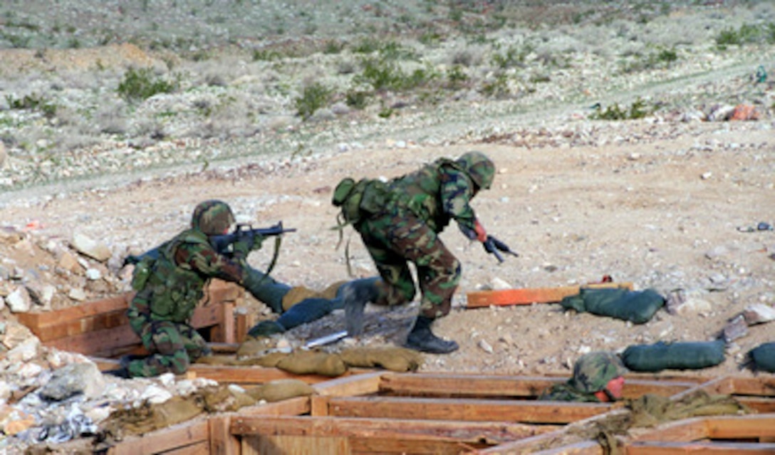 Marines from Bravo Company, 1st Battalion, 6th Marine Regiment, rush toward the target at Range 400 of the Marine Corps Air Ground Combat Center, Twentynine Palms, Calif., on Feb. 17, 1998. These Marines are taking part in Combined Arms Exercise 4-98. 