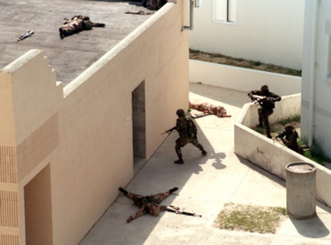 U.S. Marines from the 2nd Marine Division attack a small group of Marines role-playing as terrorists during a tactical maneuver demonstration at the Military Operations in Urban Terrain facility, Camp Lejeune, N.C., on April 15, 1998. The Marines are taking part in Capabilities Exercise at Camp Lejeune. 
