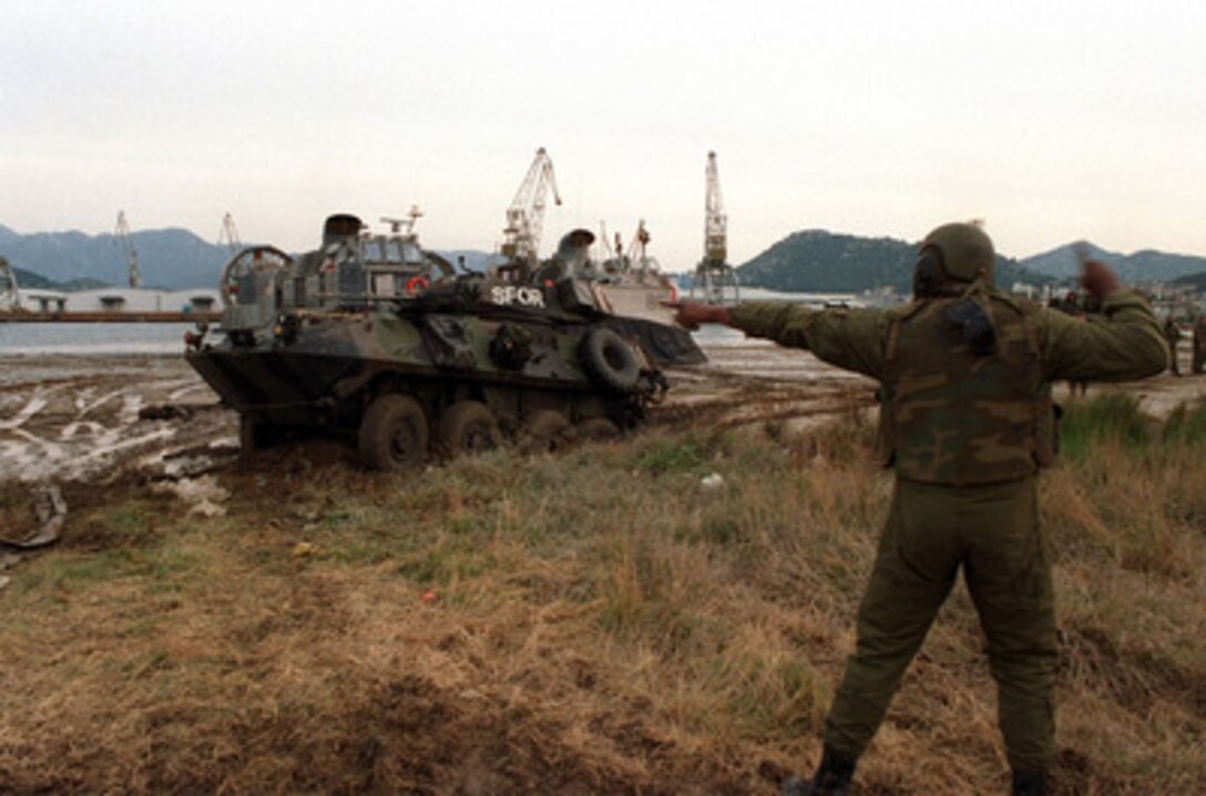 A U.S. Marine Light Armored Reconnaissance Vehicle from the 26th Marine Expeditionary Unit works through the mud as it drives off of a U.S. Navy Landing Craft Air Cushioned at Port Ploce, Croatia, on March 24, 1998. Assigned to the Strategic Reserve Force of the Stabilization Force, the Marines are taking part in Exercise Dynamic Response 98, a training exercise designed to familiarize the reserve forces with the territory and their operational capabilities within this region. 