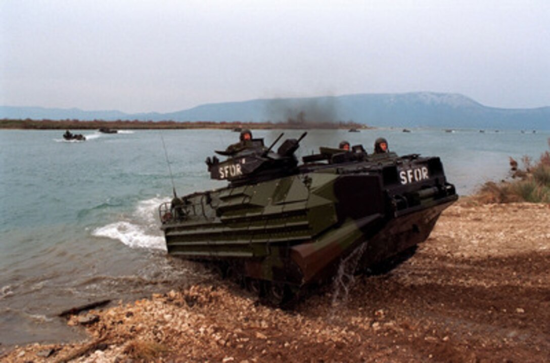 One of a long line of U.S. Marine Assault Amphibious Vehicles from the 26th Marine Expeditionary Unit comes ashore at Port Ploce, Croatia, on March 24, 1998. Assigned to the Strategic Reserve Force of the Stabilization Force, the Marines are taking part in Exercise Dynamic Response 98, a training exercise designed to familiarize the reserve forces with the territory and their operational capabilities within this region. 