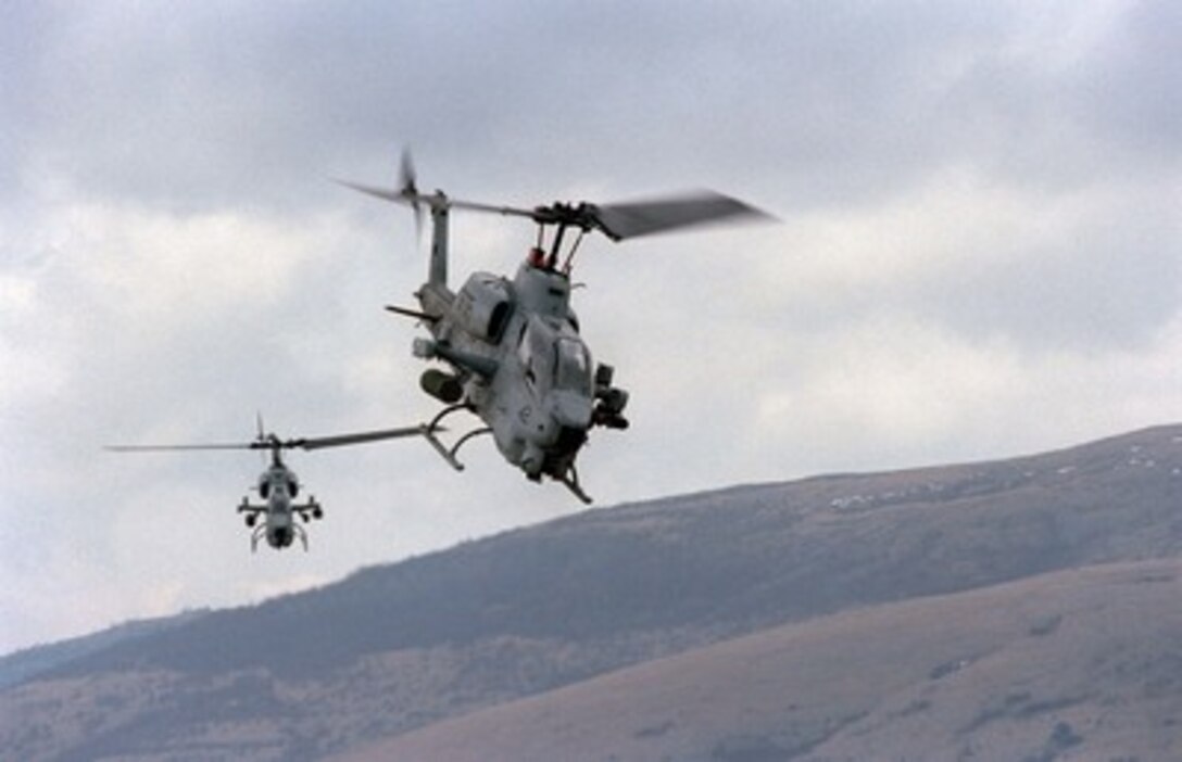 Two U.S. Marine AH-1W Super Cobra helicopters from the 26th Marine Expeditionary Unit fly over the live fire range at Glamoc, Bosnia and Herzegovina, on April 2, 1998. Assigned to the Strategic Reserve Force of the Stabilization Force, the Marines are taking part in Exercise Dynamic Response 98, a training exercise designed to familiarize the reserve forces with the territory and their operational capabilities within this region. 