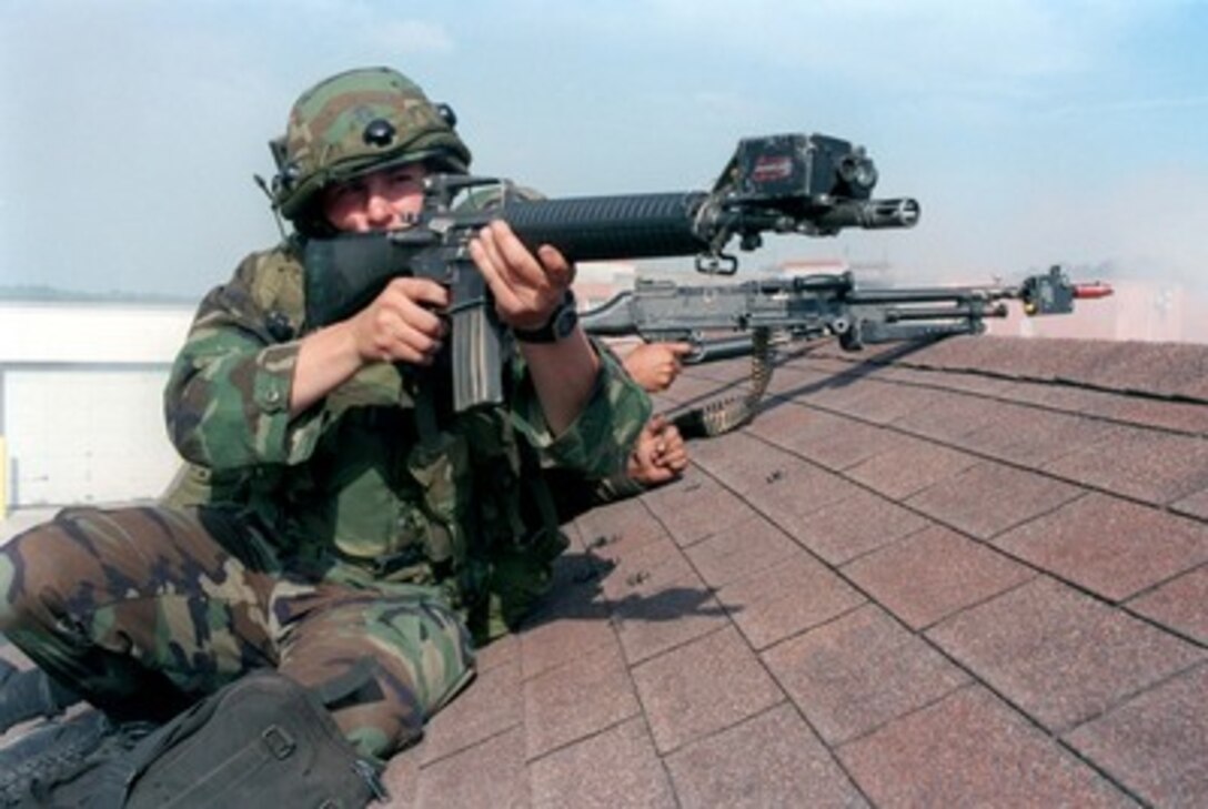 Pfc. Brian Ashavranner of Bravo Company, 1st Battalion, 8th Marines, engages the enemy with his M-16A2 service rifle from a roof at the Military Operations in Urban Terrain facility during Urban Warrior Limited Objective Exercise 2 on April 29, 1998, at Camp Lejeune, N.C. Urban Warrior is the U.S. Marine Corps Warfighting Laboratory's series of limited objective experiments examining new urban tactics and experimental technologies. 