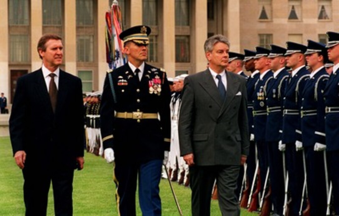 Secretary of Defense William S. Cohen (left) accompanies his guest, French Minister of Defense Alain Richard (right) as he inspects the joint services honor guard during his arrival ceremony at the Pentagon, April 30, 1998. Escorting the two defense leaders is the Commander of Troops for the ceremony, Col. Gregory Gardner, U.S. Army. 