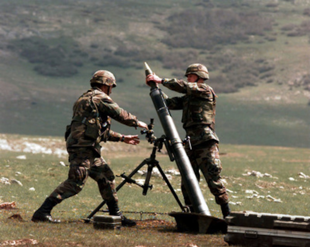 Two U.S. Army soldiers launch a mortar round on the live fire range at Glamoc, Bosnia and Herzegovina, on May 6, 1998. These 2nd Armored Cavalry Regiment soldiers are deployed to Bosnia and Herzegovina as part of the Stabilization Force in Operation Joint Guard. 