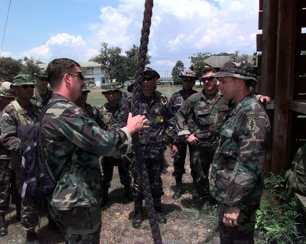 U.S. Army Staff Sgt. Sean Suttles (left), and Sgt. 1st Class Keith Looker (right), brief U.S. and Royal Thai Special Forces personnel on safety procedures prior to fast-rope training on May 17, 1998, during Exercise Cobra Gold '98. Cobra Gold '98 is the latest in a continuing series of U.S.-Thai military exercises designed to ensure regional peace and strengthen the ability of the Royal Thai Armed Forces to defend Thailand. The training includes joint combined air, land and sea operations. Cobra Gold is the largest strategic mobility exercise involving the U.S. Pacific Command forces this year. Suttles and Looker are deployed for the exercise from Bravo Company, 3rd Battalion, 1st Special Forces Group (Airborne), Fort Lewis, Wash. 