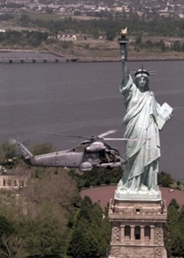 A U.S. Navy SH-2 Seasprite helicopter flies by the Statue of Liberty during the opening ceremonies of Fleet Week '98 in New York on May 20, 1998. The Seasprite is a ship based helicopter with anti-submarine and anti-ship surveillance and targeting capabilities. The Seasprite is from Light Helicopter Anti-Submarine Squadron 94, Naval Air Station Willow Grove, Pa. 