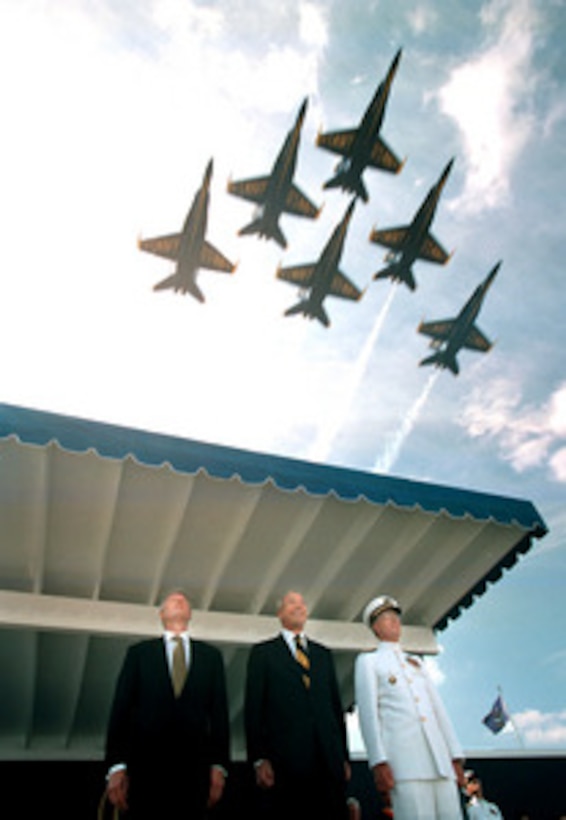 President William J. Clinton (left), Secretary of the Navy John H. Dalton (center) and Academy Superintendent Admiral Charles R. Larson, U.S. Navy, look skyward as the Navy Blue Angels fly over the Naval Academy stadium on May 22, 1998, to kick off the graduation and commissioning ceremonies for the U.S. Naval Academy class of 1998. 