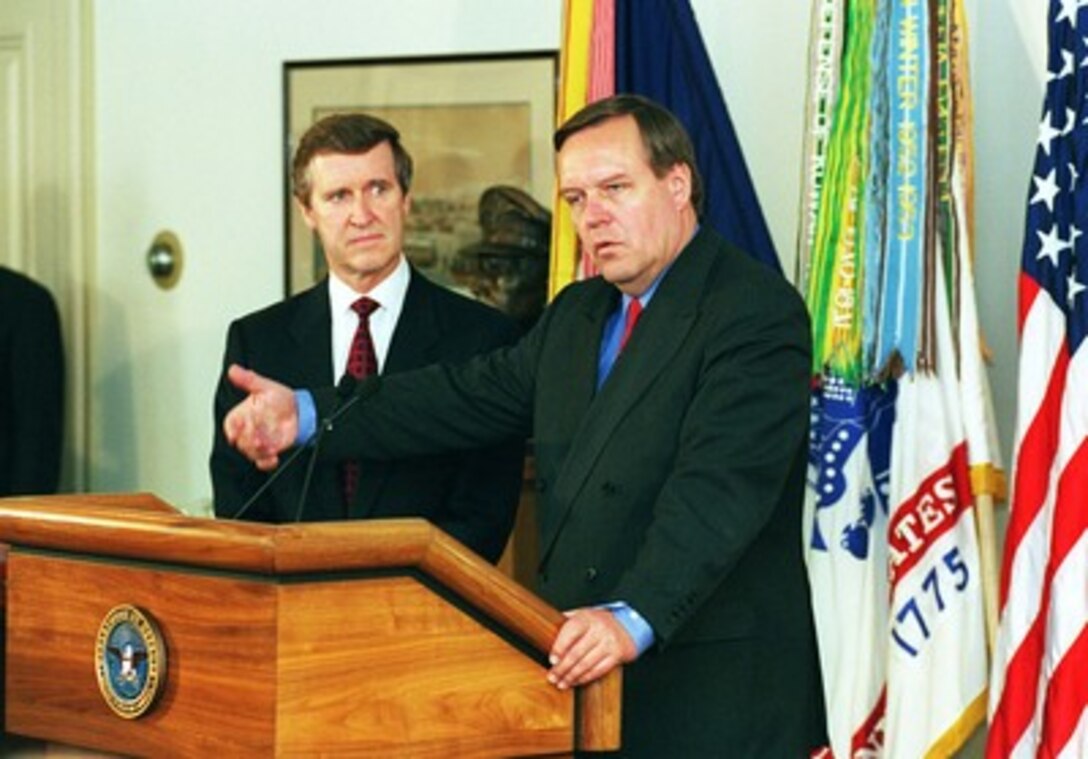 German Defense Minister Volker Ruehe (right) responds to a reporter's question concerning his views on NATO enlargement during a Pentagon press conference with Secretary of Defense William Cohen (left), on May 20, 1998. 