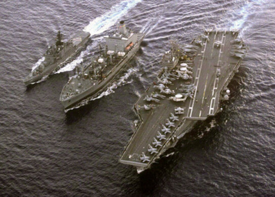 The USNS Tippecanoe (TAO 199) (center) conducts an underway replenishment with the Japanese Maritime Self-Defense Force destroyer Haruna (DD 141) (left) and the aircraft carrier USS Kitty Hawk (CV 63) on Oct. 8, 1998. The Kitty Hawk and her escorts are conducting joint exercises with the Japanese Maritime Self-Defense Force. 
