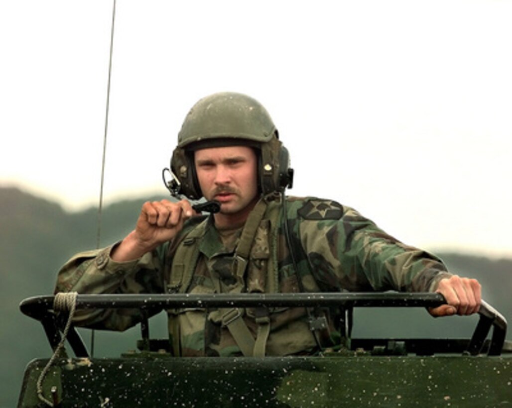 Track Commander Sgt. Mike Stacher, U.S. Army, from 6th Battalion, 37th Field Artillery, Bravo Battery, guides his M-270 Multiple Launch Rocket System during a combined training exercise with the Republic of Korea's 3rd ROK Corps, on Oct. 15, 1998, at Camp Red Cloud, Republic of Korea. The training allows soldiers from both armies a chance to see how the other operates and to use joint tactics to capitalize on combined strengths. 