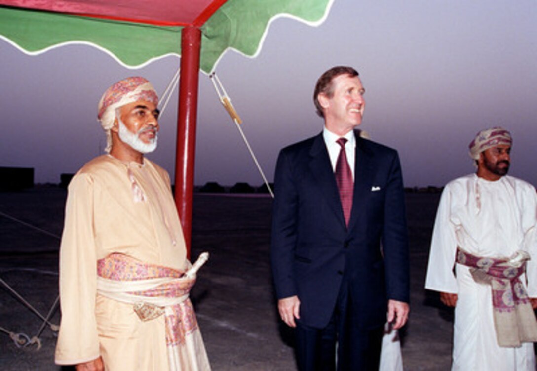 Sultan Qaboos bin Said (left), Secretary of Defense William S. Cohen (center), and Minister Responsible for Defense Affairs His Excellency Sayyid Badr bin Saíud bin Harib al-Busaíidi (right) await the American delegation at the Sultan's desert encampment near Sohar, Oman, on Oct. 11, 1998. Cohen is in the Persian Gulf region to visit with U.S. troops and heads of state in the Gulf countries. 