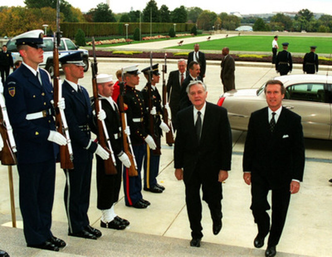 Secretary of Defense William S. Cohen (right) escorts President Valdas Adamkus (left), of the Republic of Lithuania, through an armed forces honor cordon into the Pentagon on Oct. 22, 1998. 