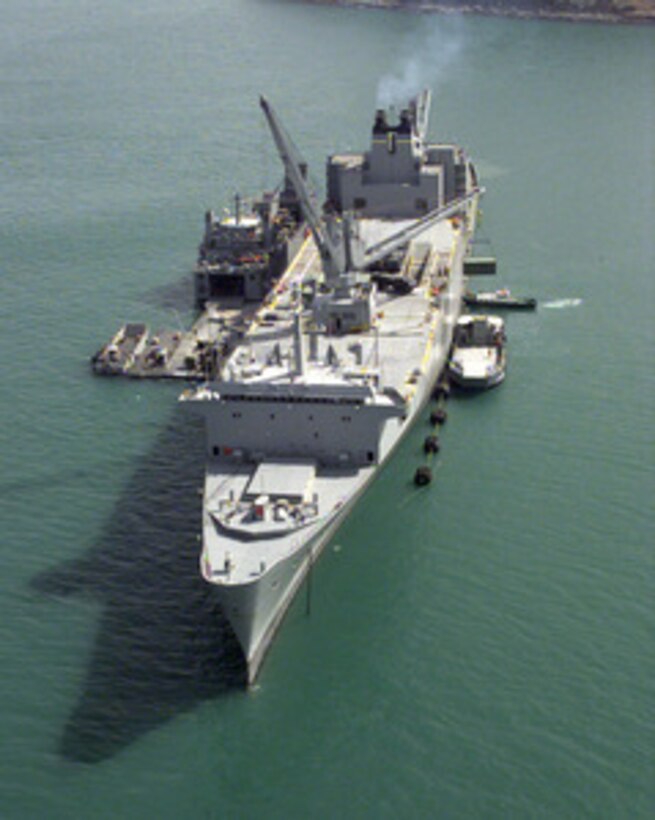 The USNS Pollux off-loads vehicles and equipment for Exercise Foal Eagle '98 while anchored in the harbor of Pusan, Republic of Korea, on Oct. 19, 1998. Attached to the starboard side of the Pollux is a temporary roll-on, roll-off discharge facility which provides a causeway for vehicles to move from the Pollux to lighter craft for transportation to the shore. Foal Eagle '98 is a combined, joint exercise supported by forces from the U.S. and Republic of Korea. In addition to providing hands-on field experience for forces of both nations, Foal Eagle '98 was designed to test rear area protection operations and major command, control and communications systems. Pollux is one of eight Fast Sealift Ships belonging to the Military Sealift Command that have special features allowing them to load and off-load cargo in places lacking normal port facilities. 