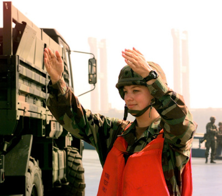 Spec. Daphne Wright, U.S. Army, directs the flow of vehicles being off loaded at the port of Pyongtaek, Republic of Korea, on Oct. 24, 1998, for Exercise Foal Eagle '98. Foal Eagle '98 is a combined, joint exercise supported by forces from the U.S. and Republic of Korea. In addition to providing hands-on field experience for forces of both nations, Foal Eagle '98 was designed to test rear area protection operations and major command, control and communications systems. Wright is a deck seaman assigned to the U. S. Army Logistics Support Vessel Gen. Brehon B. Somervell. 