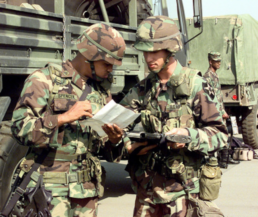 U.S. Army Sgt. Anthony Spencer (left) checks the serial number of Pvt. Paul Grebinger's (right) M-16A2 rifle in the port of Pyongtaek, Republic of Korea, on Oct. 24, 1998. The two soldiers are preparing to convoy to Camp Casey, Republic of Korea, for Exercise Foal Eagle '98. Foal Eagle '98 is a combined, joint exercise supported by forces from the U.S. and Republic of Korea. In addition to providing hands-on field experience for forces of both nations, Foal Eagle '98 was designed to test rear area protection operations and major command, control and communications systems. Spencer and Grebinger are assigned to the 1st Battalion, 23rd Infantry, 3rd Brigade, Fort Lewis, Wash. 