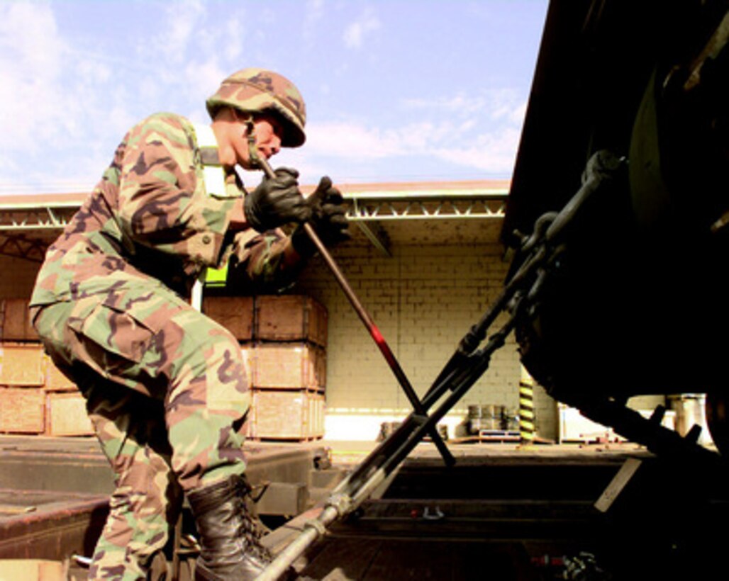 Sgt. Nara Tith, U.S. Army, uses a steel bar to tighten one of the turnbuckles holding an M-3 Bradley Fighting Vehicle in place on a flat bed railroad car at the rail head at Camp Carroll, Republic of Korea, on Oct. 26, 1998, during Exercise Foal Eagle '98. Foal Eagle '98 is a combined, joint exercise supported by forces from the U.S. and Republic of Korea. In addition to providing hands-on field experience for forces of both nations, Foal Eagle '98 was designed to test rear area protection operations and major command, control and communications systems. Tith, of Bravo Company, 1st Battalion, 23rd Infantry, is a participant in the railhead exercise that will move the 23rd Infantry's equipment to Camp Casey in support of Foal Eagle '98. 