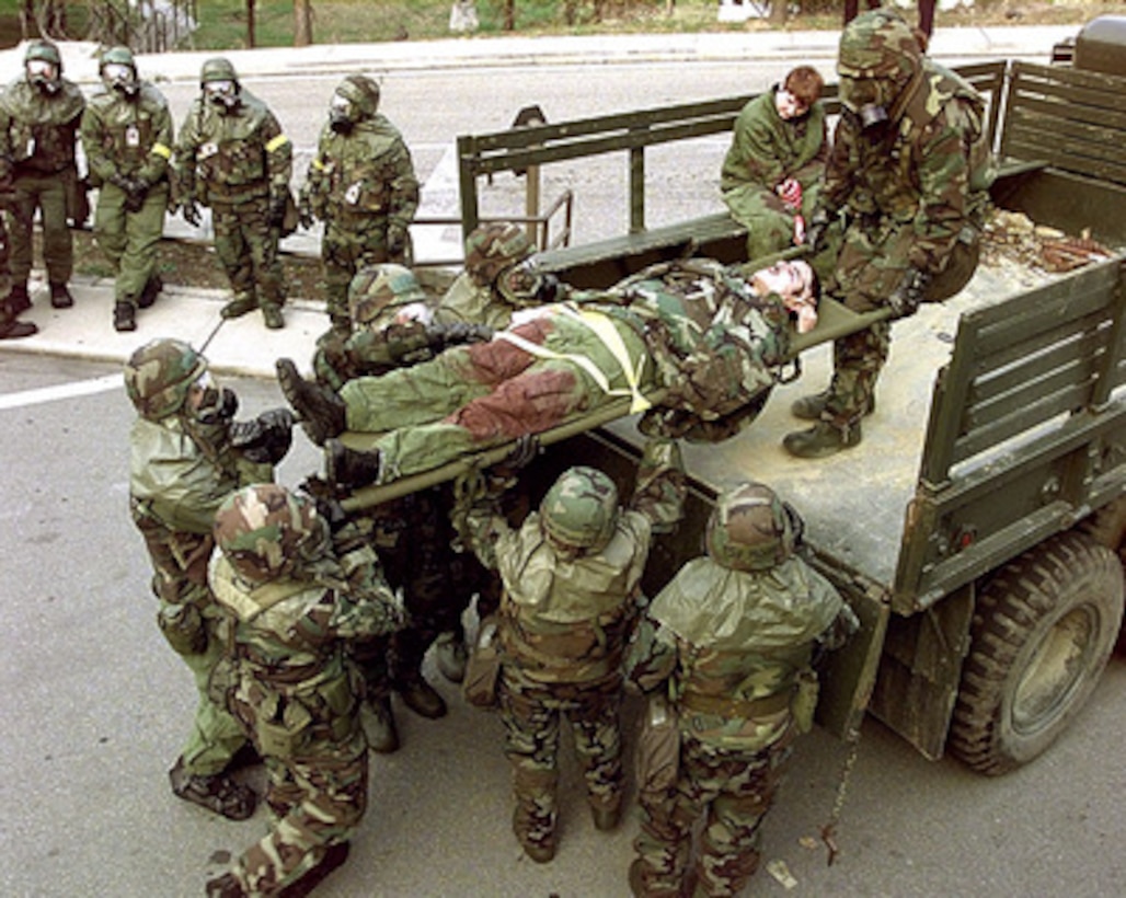 Simulated casualty Senior Airman Jose Rivera, U.S. Air Force, is loaded on a truck for transport to the hospital during a simulated chemical attack at Osan Air Base, Republic of Korea, on Oct. 29, 1998, during Exercise Foal Eagle '98. Foal Eagle '98 is a combined, joint exercise supported by forces from the U.S. and Republic of Korea. In addition to providing hands-on field experience for forces of both nations, Foal Eagle '98 was designed to test rear area protection operations and major command, control and communications systems. Rivera is attached to the 303rd Intelligence Squadron at Osan. 