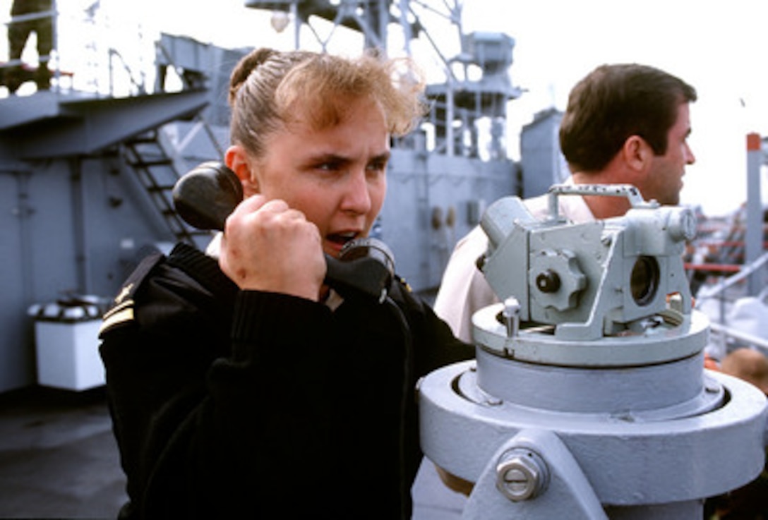 Lt. j.g. Diane Quattrone (left), U.S. Navy, gives course and rudder orders to the helmsman on the USS Germantown (LSD 42) on Oct. 30, 1998, as the ship operates off the coast of the Republic of Korea during Exercise Foal Eagle '98. Foal Eagle '98 is a combined, joint exercise supported by forces from the U.S. and Republic of Korea. In addition to providing hands-on field experience for forces of both nations, Foal Eagle '98 was designed to test rear area protection operations and major command, control and communications systems. 
