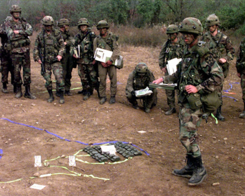 U.S. Army 1st Lt. Thomas Nelson uses a terrain model as he briefs the platoon commanders of Task Force 123 at Tactical Assembly Area Santa Barbara outside Wonapsan, Republic of Korea, Oct. 31, 1998, for Exercise Foal Eagle '98. Foal Eagle '98 is a combined, joint exercise supported by forces from the U.S. and Republic of Korea. In addition to providing hands-on field experience for forces of both nations, Foal Eagle '98 was designed to test rear area protection operations and major command, control and communications systems. Nelson is the Scout Platoon Commander for the 1st Battalion, 23rd Infantry Regiment from the 3rd Brigade, 2nd Infantry Division Fort Lewis, Wash. 