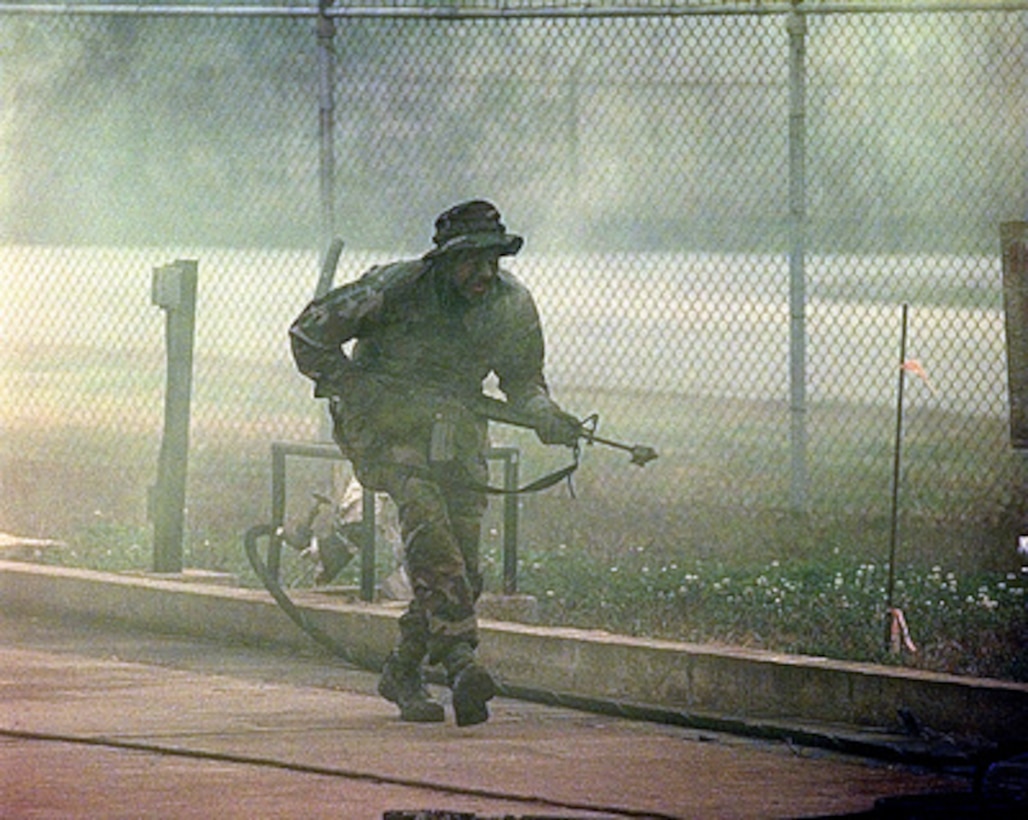 A role playing aggressor attacks the 607th Combat Communications Squadron compound at Camp Humphreys, Republic of Korea, on Oct. 30, 1998, as part of Exercise Foal Eagle '98. Foal Eagle '98 is a combined, joint exercise supported by forces from the U.S. and Republic of Korea. In addition to providing hands-on field experience for forces of both nations, Foal Eagle '98 was designed to test rear area protection operations and major command, control and communications systems. The simulated attack was part of a combat employment readiness exercise. 