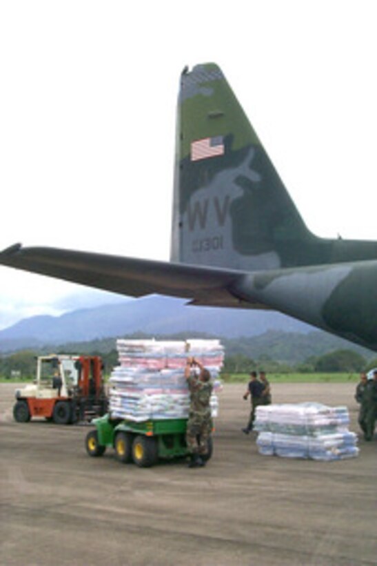Mattresses and relief supplies for victims of Hurricane Mitch are unloaded from a West Virginia Air National Guard C-130 Hercules at the airport in La Cieba, Honduras, on Nov. 11, 1998. Over 1,000 U.S. service members are helping to rush food, shelter, pure water and medical aid to the central Americans made homeless by Hurricane Mitch. 